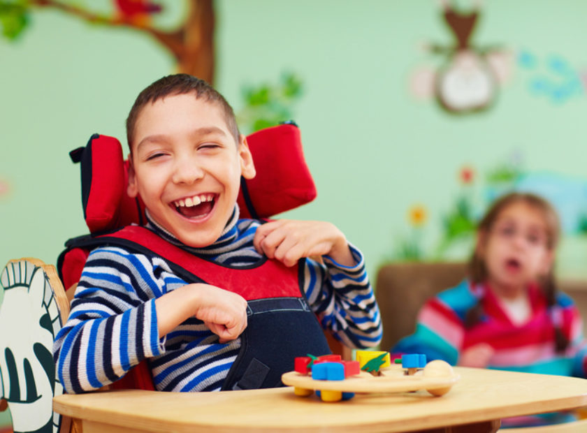 cheerful boy with disability at rehabilitation center for kids with special needs